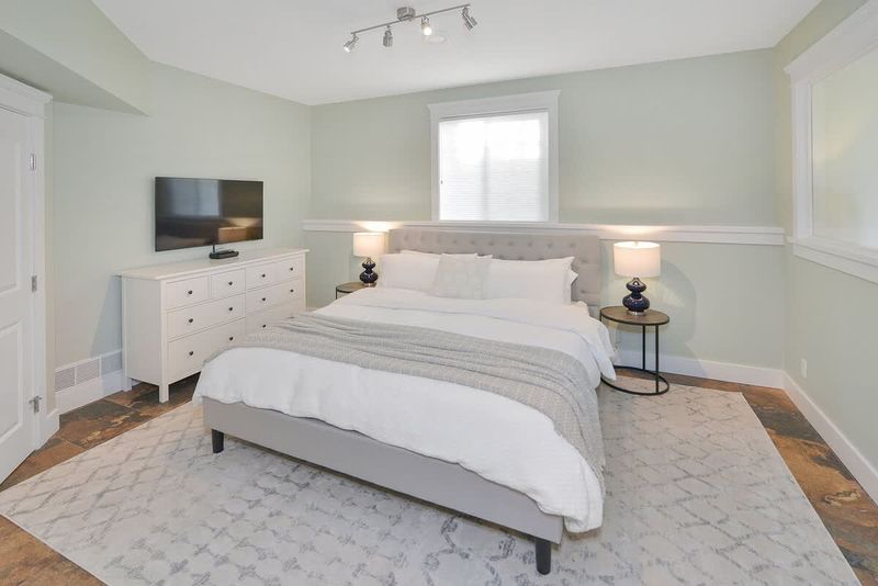 Lower floor seventh bedroom with king bed.