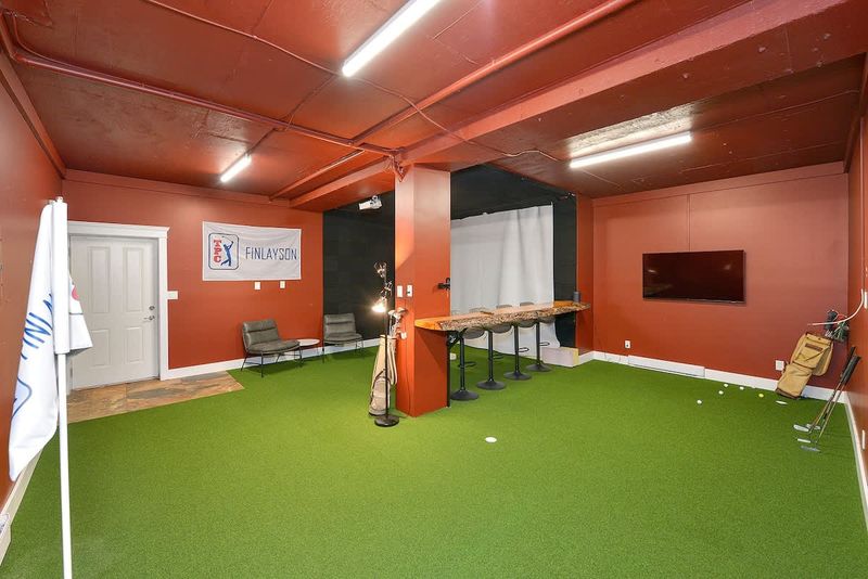 Indoor golf putting room on the lower floor.