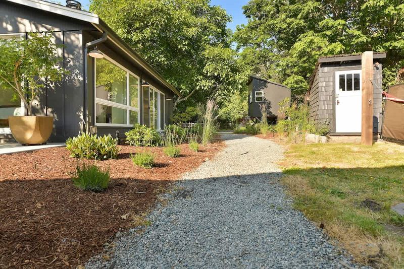 Backyard path between the third bedroom cottage.