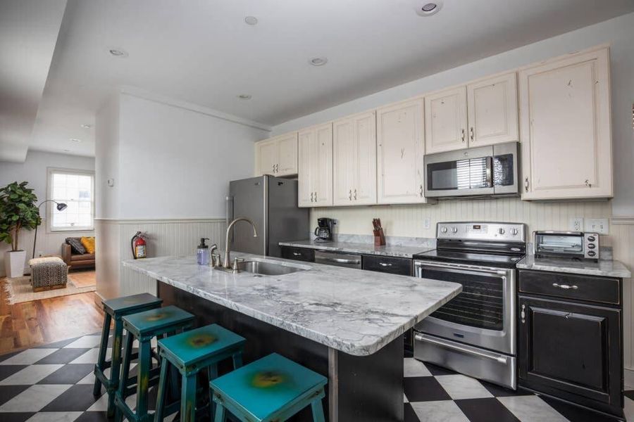 Fully stocked kitchen with bar seating!