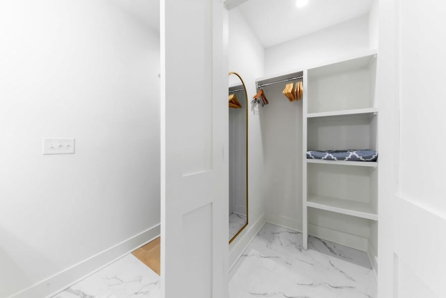 Keep your clothes clean and wrinkle-free in the spacious closet with hangers and shelves.