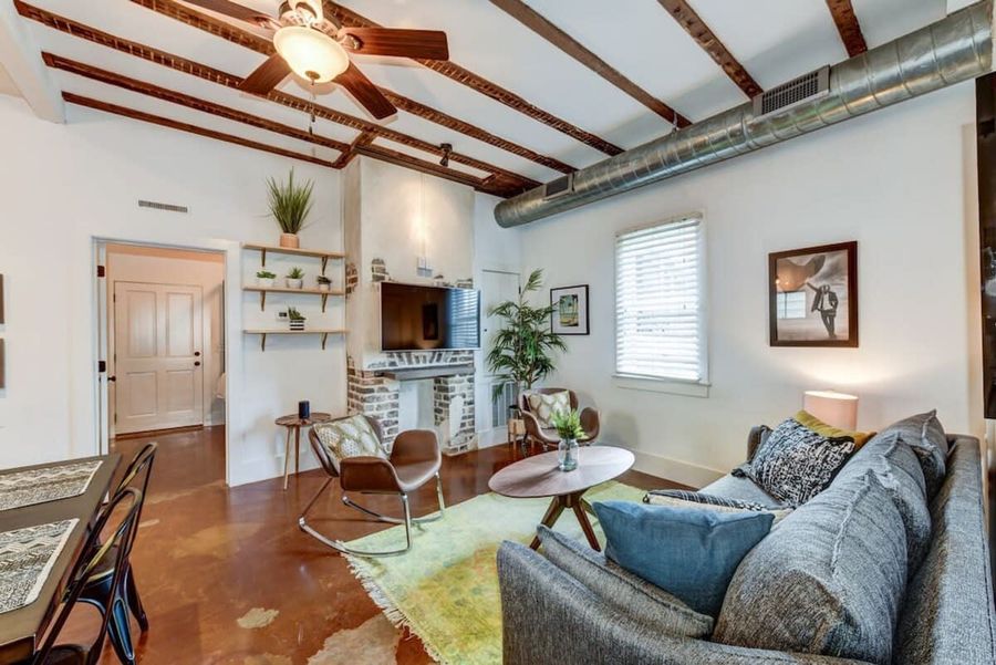 The sunshine soaked living room, decorated by a Charleston local decorator is the perfect place to relax after a day of exploring the city!