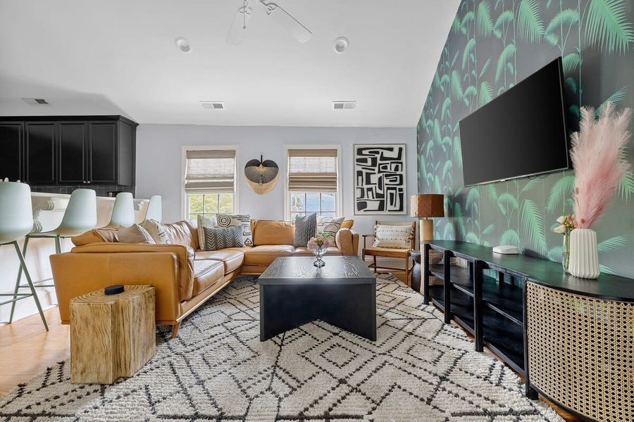 The house is made up of 4 total units. Every unit is made up of 2 bedrooms, 1 bath, kitchen, living room with a washer/dryer! This is living room #1! 