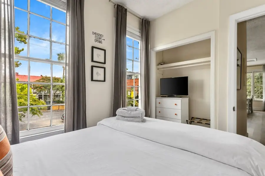 Bedroom 1: Queen Bed + TV + Ceiling Fan