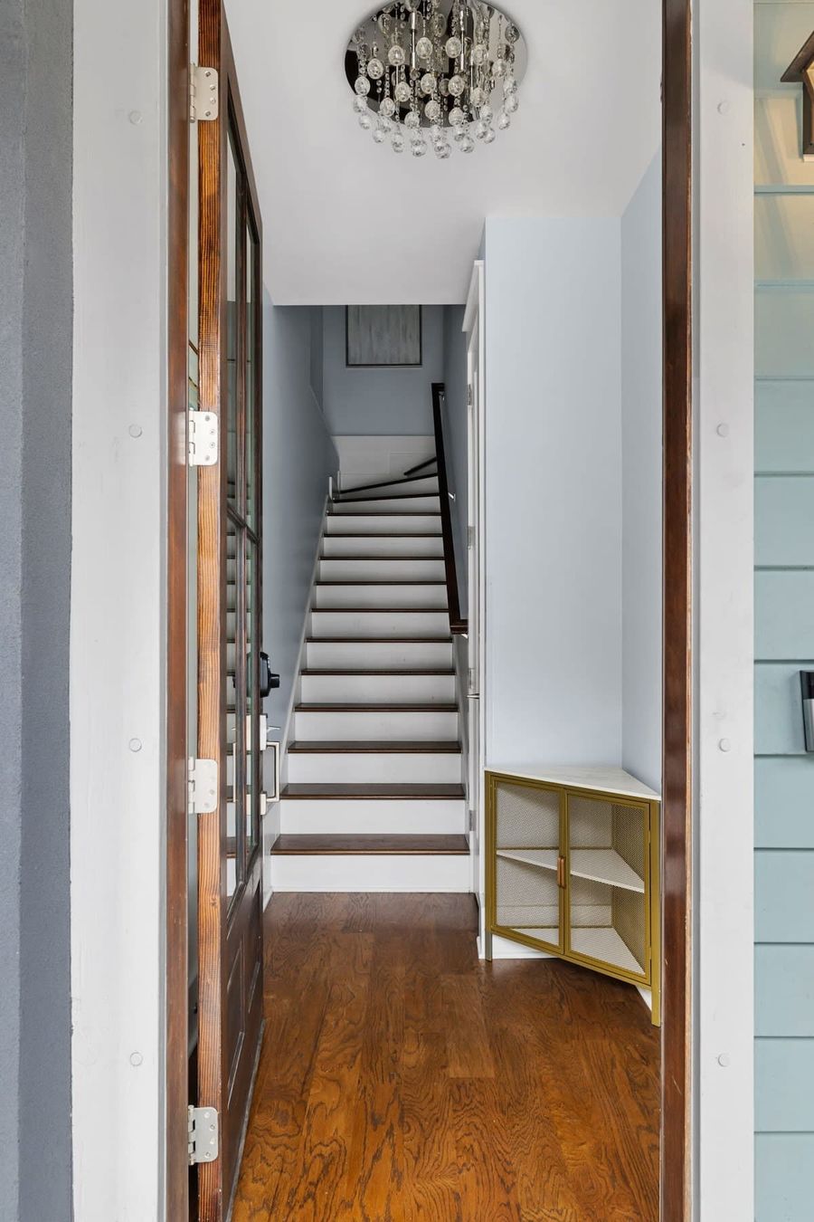 Entryway leading up to kitchen and living area