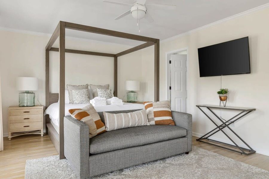 Bedroom #1 with King Bed + Pullout Couch + TV + En Suite Bathroom + Balcony