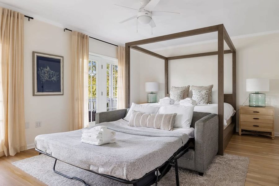 Bedroom #1 with King Bed + Pullout Couch + TV + En Suite Bathroom + Balcony
