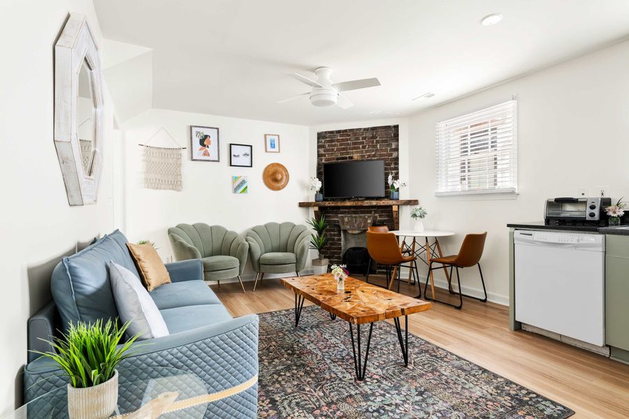 Open space layout featuring living room with plenty of seating space for your group, TV and kitchen with dining and seating for three