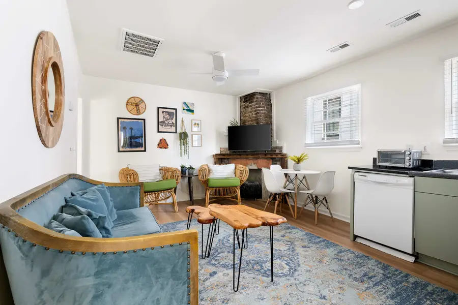 Open space layout featuring living room with plenty of seating space for your group, TV and kitchen with dining and seating for three