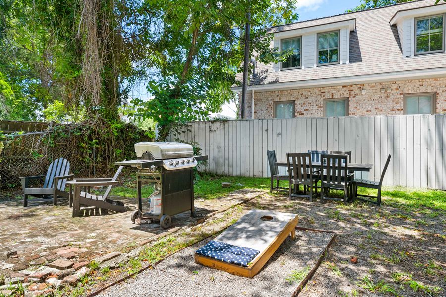 Backyard space with seating and a grill