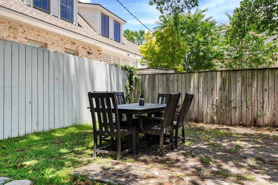 Backyard space with seating and a grill