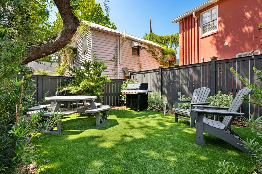 Outdoor common area space with seating and a grill 