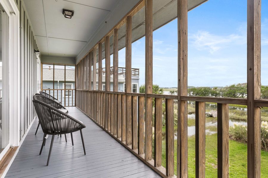 Outdoor seating on the back screened in porch that overlooks Folly Creek! 