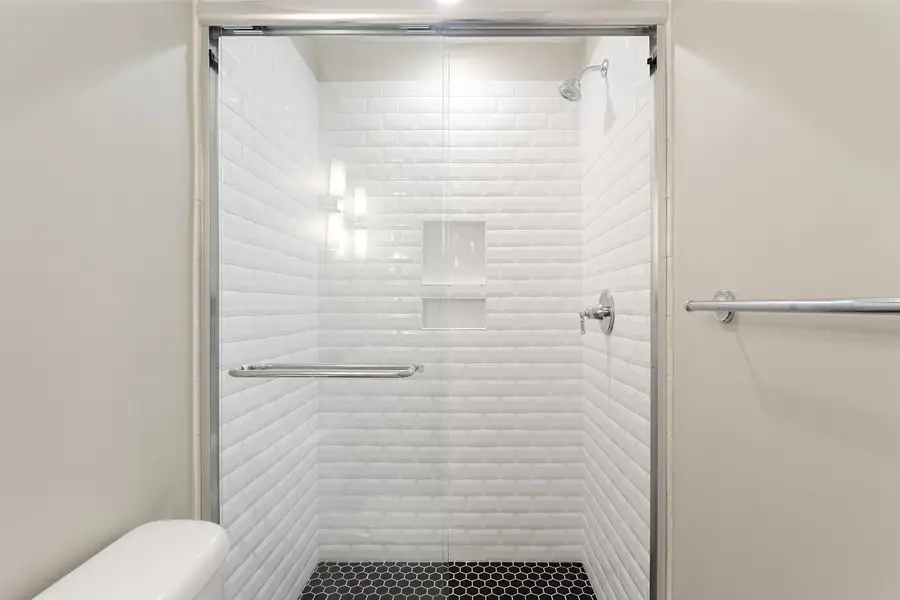 Bathroom 1: Refresh in the sleek bathroom featuring a spacious walk-in shower.