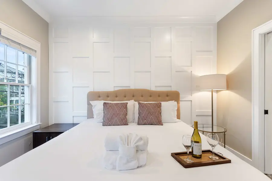 Bedroom 1: Relax in a king bed with natural light, a TV, and an attached private bath.