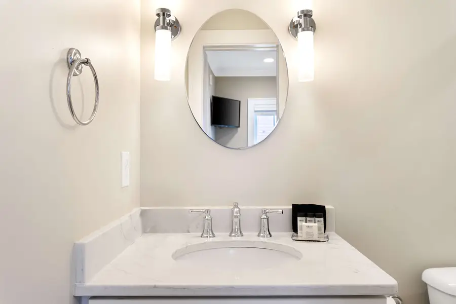 Bathroom 1: Refresh in the sleek bathroom featuring a spacious walk-in shower.