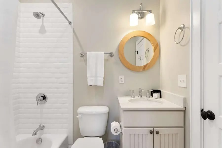 Bathroom 2: Spa-inspired bathroom featuring a walk-in shower and soaking tub.