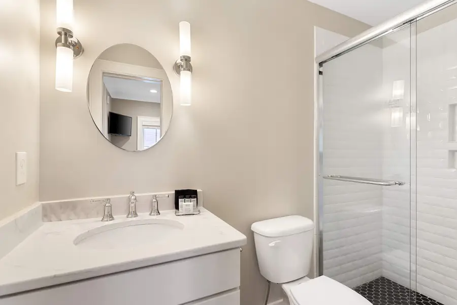 Bathroom 1: Refresh in the sleek bathroom featuring a spacious walk-in shower.