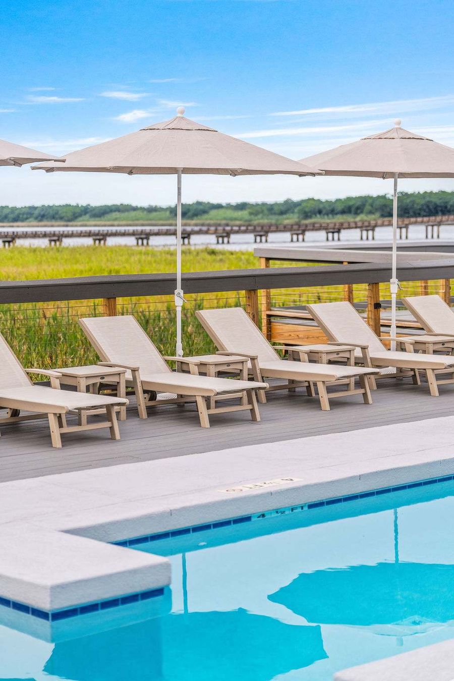 Lounge by the sparkling pool, sip cocktails from the poolside bar, and soak up the laid-back elegance of Winyah Bay Club