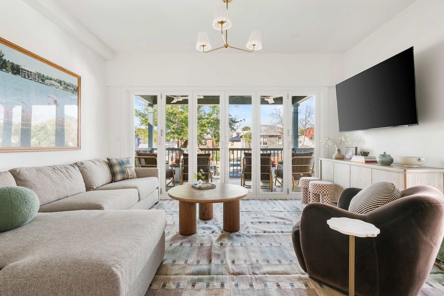Spacious living room with folding doors that open to the porch 