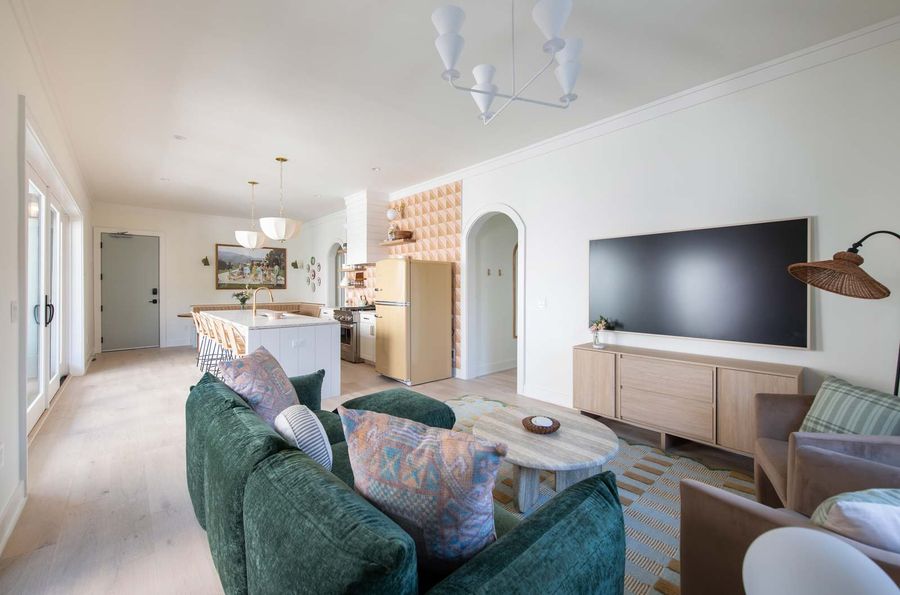 Designed with entertaining in mind, this open living area blends form and function with art-forward details and inviting comfort.