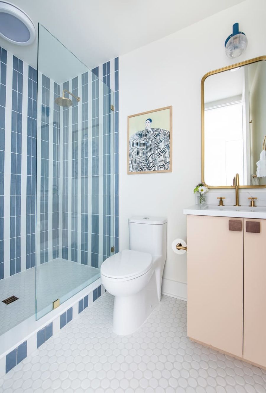 Modern fixtures and layered textures bring an editorial edge to everyday rituals.