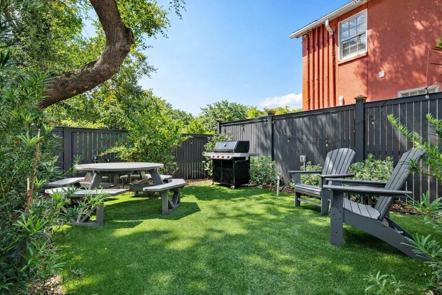 Outdoor common area space with seating and a grill! 