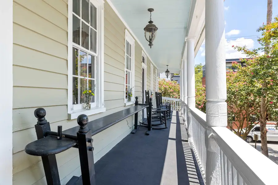 Upstairs porch seating with Charleston joggling benches :) 