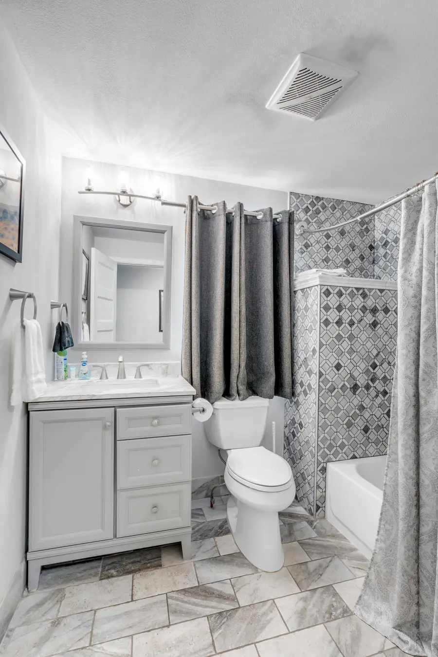 Bathroom 2: Well-appointed bath with a shower/tub combo, perfect for a quick rinse or a relaxing soak.