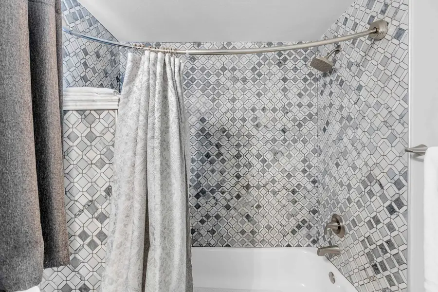 Bathroom 2: Well-appointed bath with a shower/tub combo, perfect for a quick rinse or a relaxing soak.