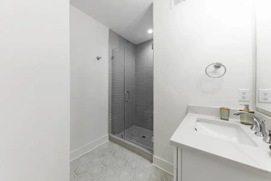 Bathroom 2: A well-appointed bathroom with a walk-in shower and modern finishes.