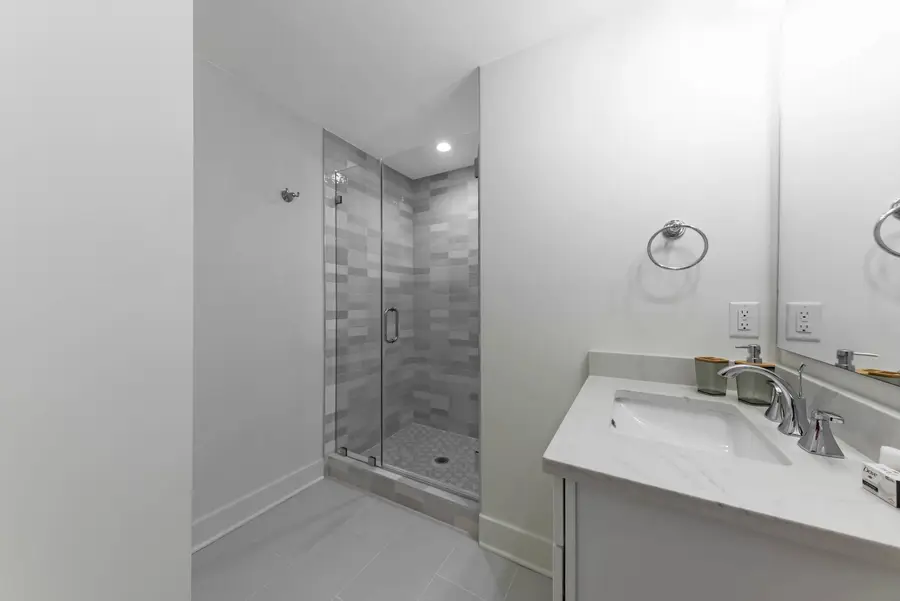 Bathroom 2: A well-appointed bathroom with a walk-in shower and modern finishes.