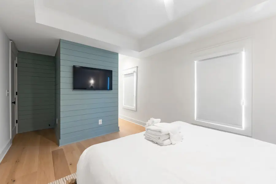 Bedroom 1: Rest comfortably in a queen bed with a private ensuite bath and TV.