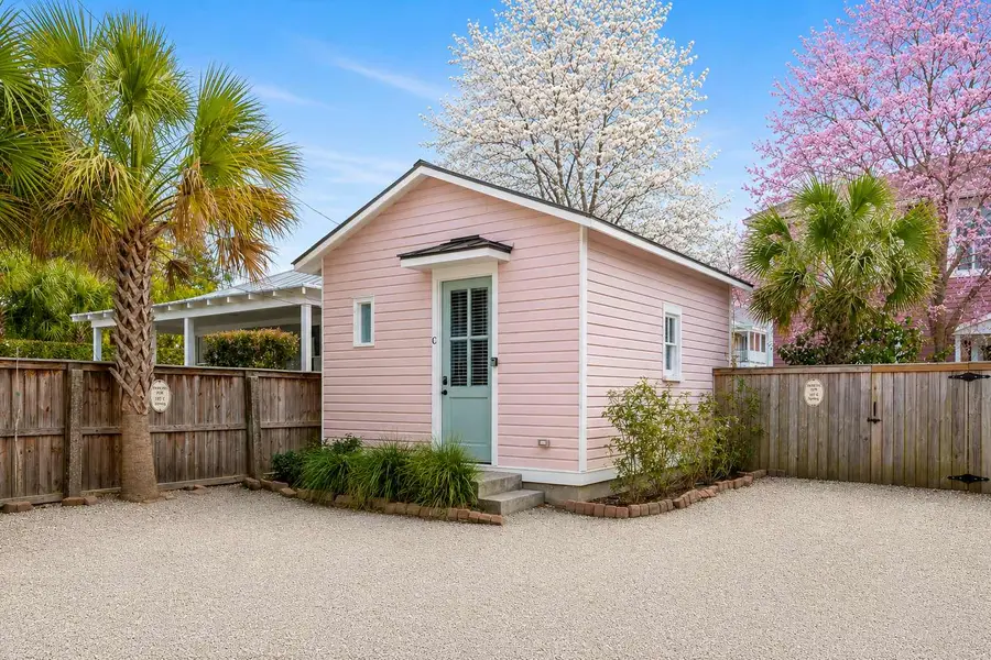 Cute and perfect Carolina exterior surrounded by palm trees!