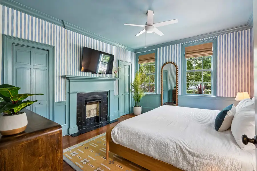 Bedroom #1: Comfortable king bed, TV, and abundant natural light, creating a warm and inviting retreat after a day of exploring.