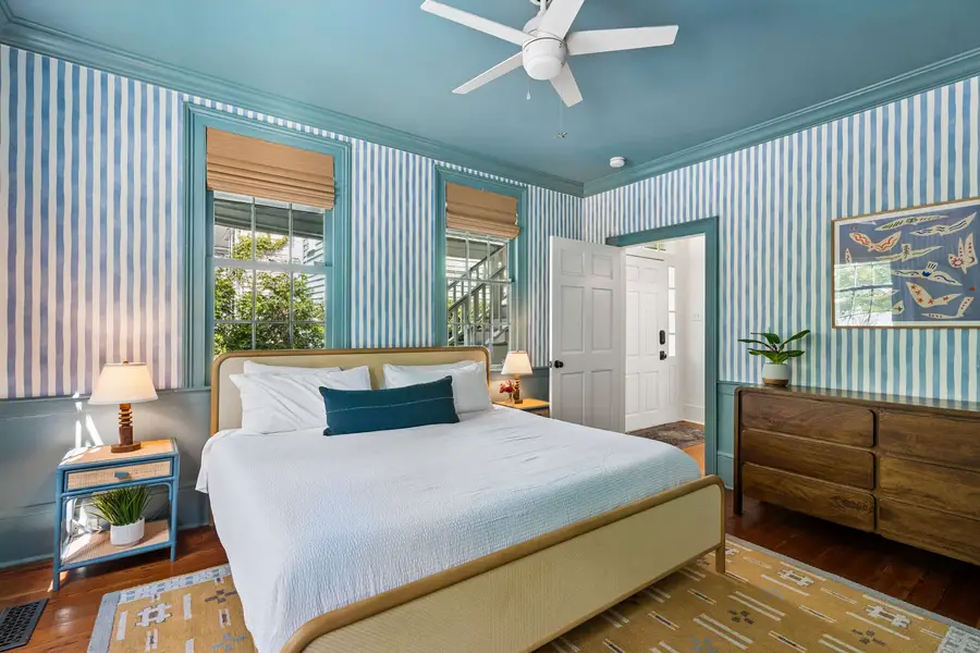 Bedroom #1: Comfortable king bed, TV, and abundant natural light, creating a warm and inviting retreat after a day of exploring.