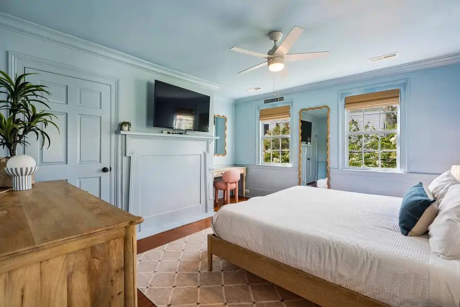 Bedroom #1: Features a king bed, Smart TV, abundant natural light, and a dedicated vanity/work desk for a comfortable and versatile stay.