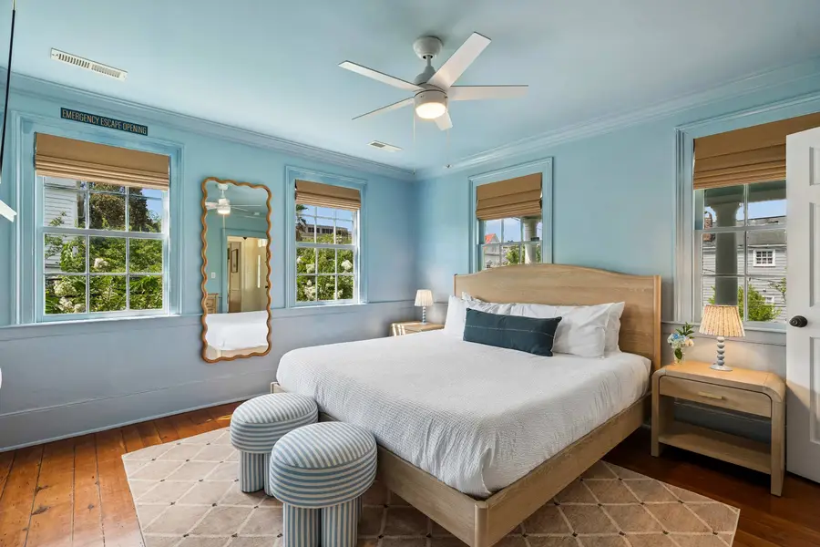 Bedroom #3: Features a king bed, Smart TV, abundant natural light, and a dedicated vanity/work desk for a comfortable and versatile stay.