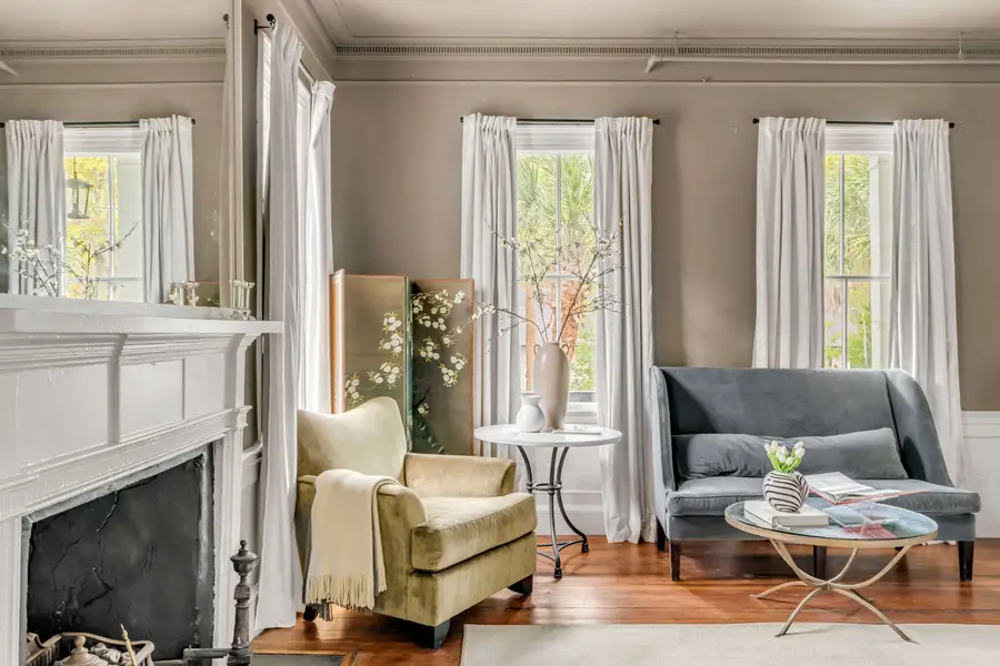 Bedroom #1: Bright, elegant, and inviting, this king suite offers a plush bed, cozy sofa, TV, and plenty of natural light for a truly relaxing stay.