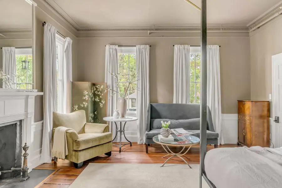 Bedroom #1: Bright, elegant, and inviting, this king suite offers a plush bed, cozy sofa, TV, and plenty of natural light for a truly relaxing stay.