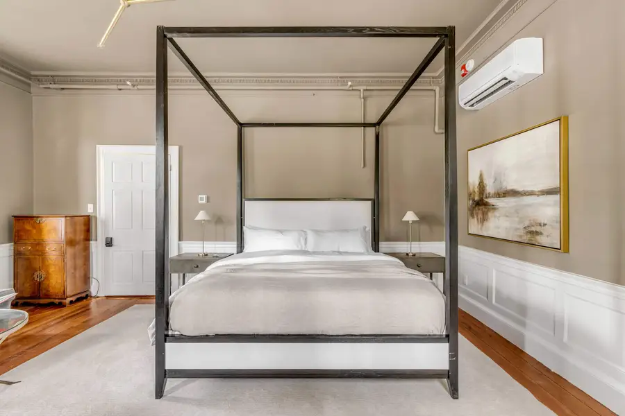 Bedroom #1: Bright, elegant, and inviting, this king suite offers a plush bed, cozy sofa, TV, and plenty of natural light for a truly relaxing stay.