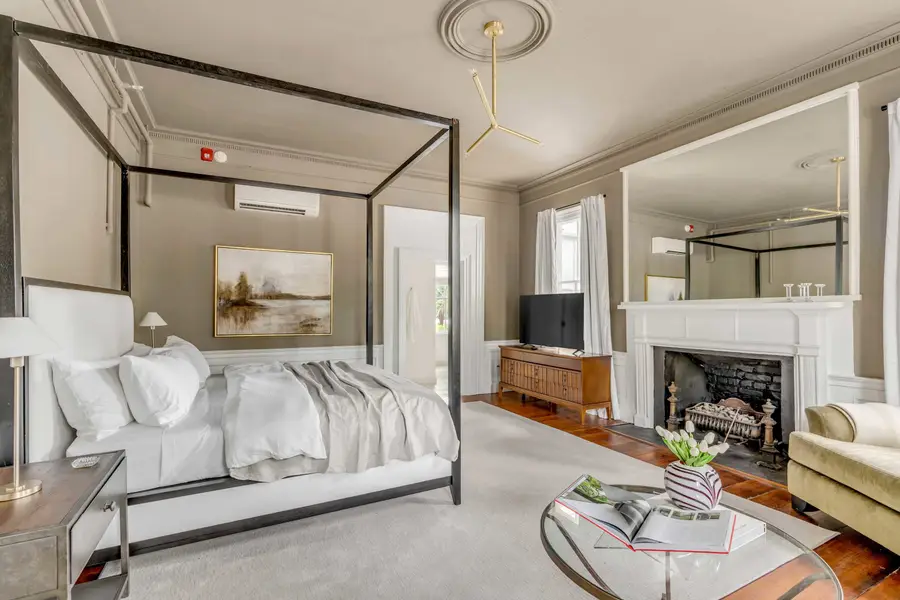 Bedroom #1: Bright, elegant, and inviting, this king suite offers a plush bed, cozy sofa, TV, and plenty of natural light for a truly relaxing stay.