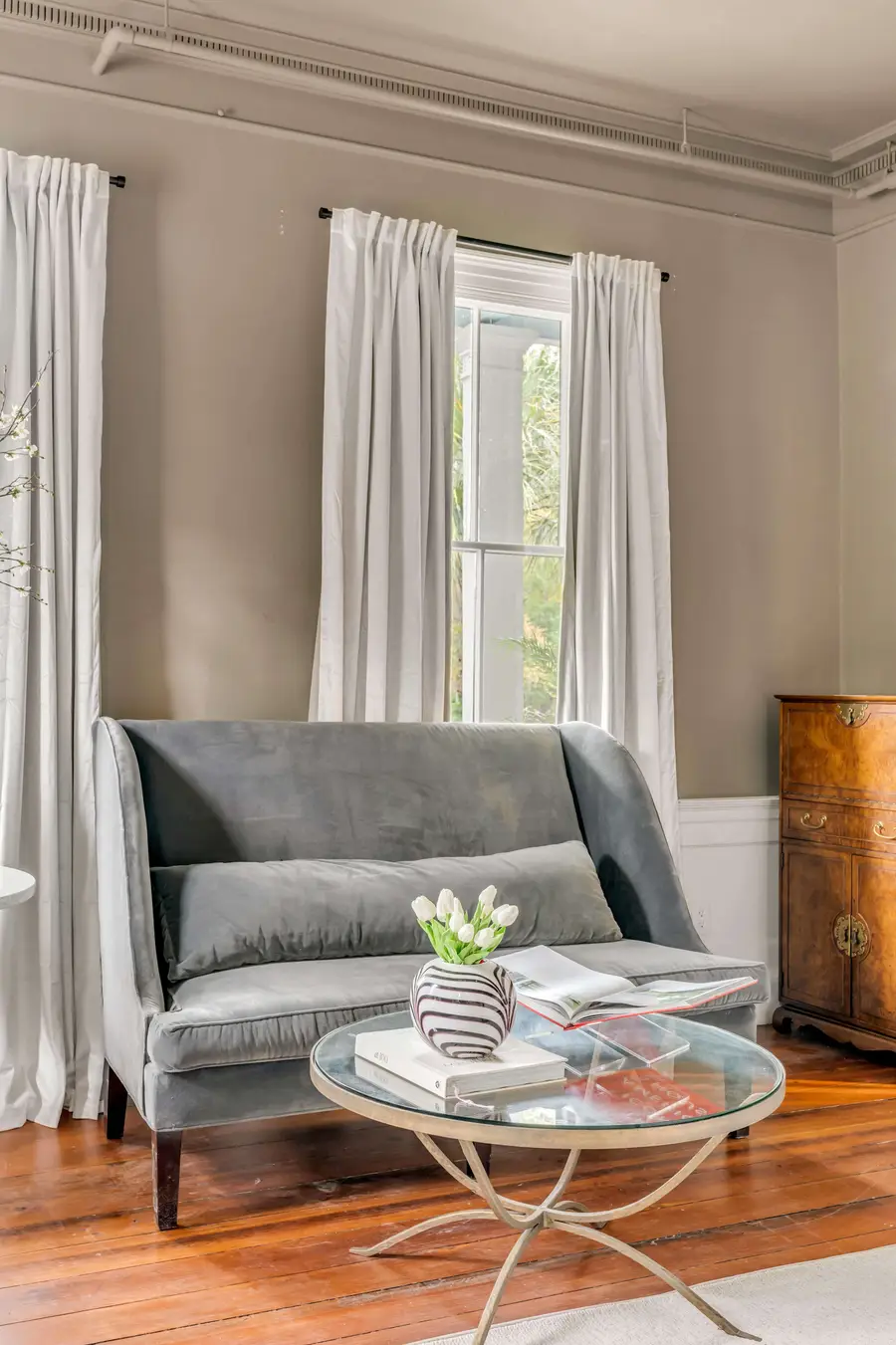 Bedroom #1: Bright, elegant, and inviting, this king suite offers a plush bed, cozy sofa, TV, and plenty of natural light for a truly relaxing stay.
