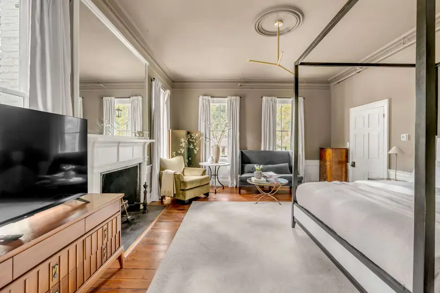 Bedroom #1: Bright, elegant, and inviting, this king suite offers a plush bed, cozy sofa, TV, and plenty of natural light for a truly relaxing stay.