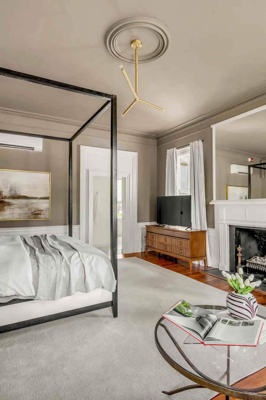 Bedroom #1: Bright, elegant, and inviting, this king suite offers a plush bed, cozy sofa, TV, and plenty of natural light for a truly relaxing stay.