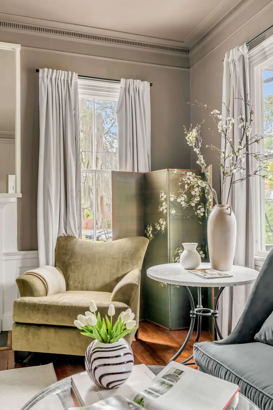 Bedroom #1: Bright, elegant, and inviting, this king suite offers a plush bed, cozy sofa, TV, and plenty of natural light for a truly relaxing stay.