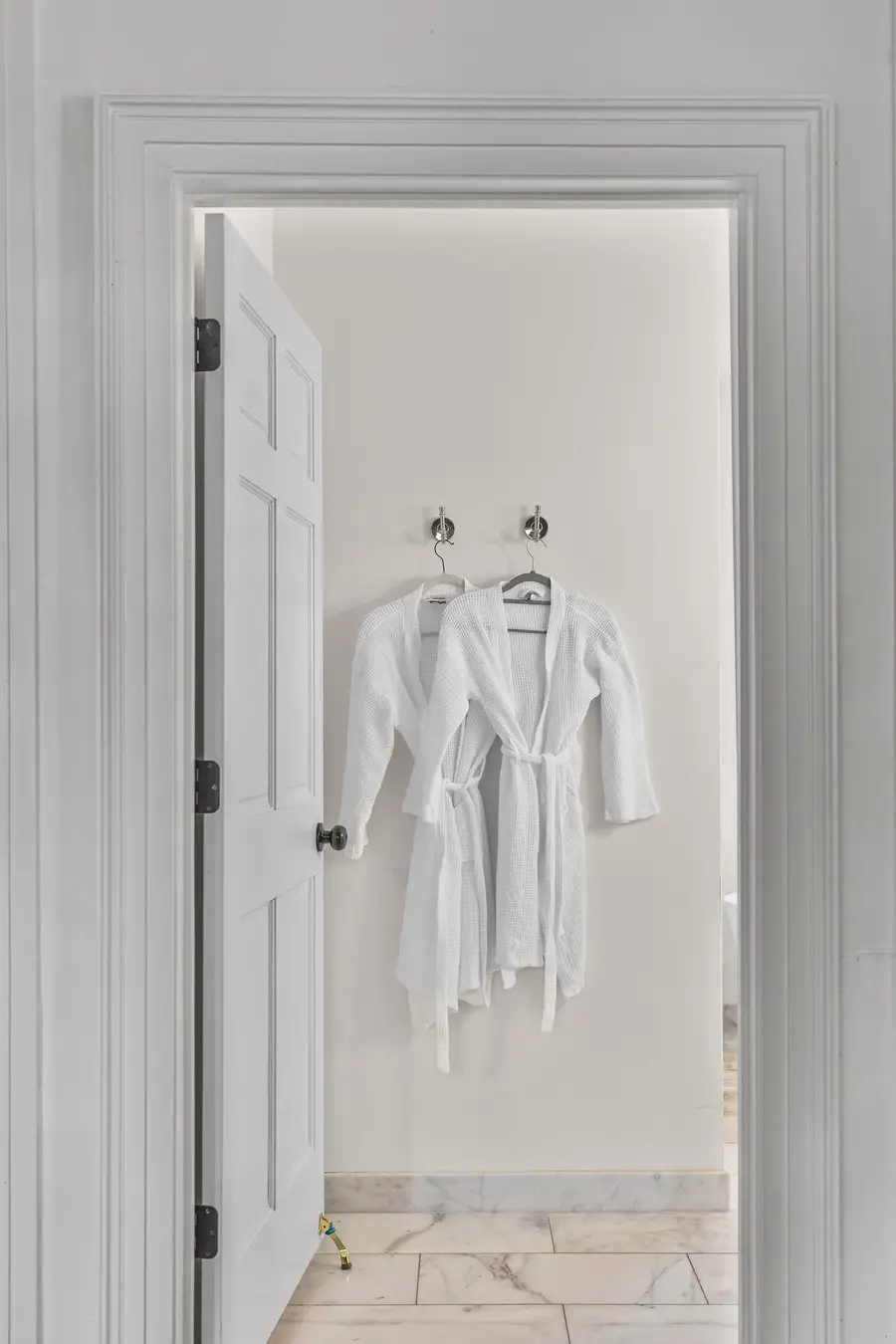 Bathroom #1: Indulge in a spa-like retreat featuring a soaking tub, walk-in shower, dual vanities, plush bathrobes, and elegant luxury finishes.
