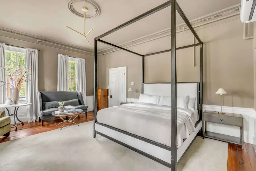 Bedroom #1: Bright, elegant, and inviting, this king suite offers a plush bed, cozy sofa, TV, and plenty of natural light for a truly relaxing stay.