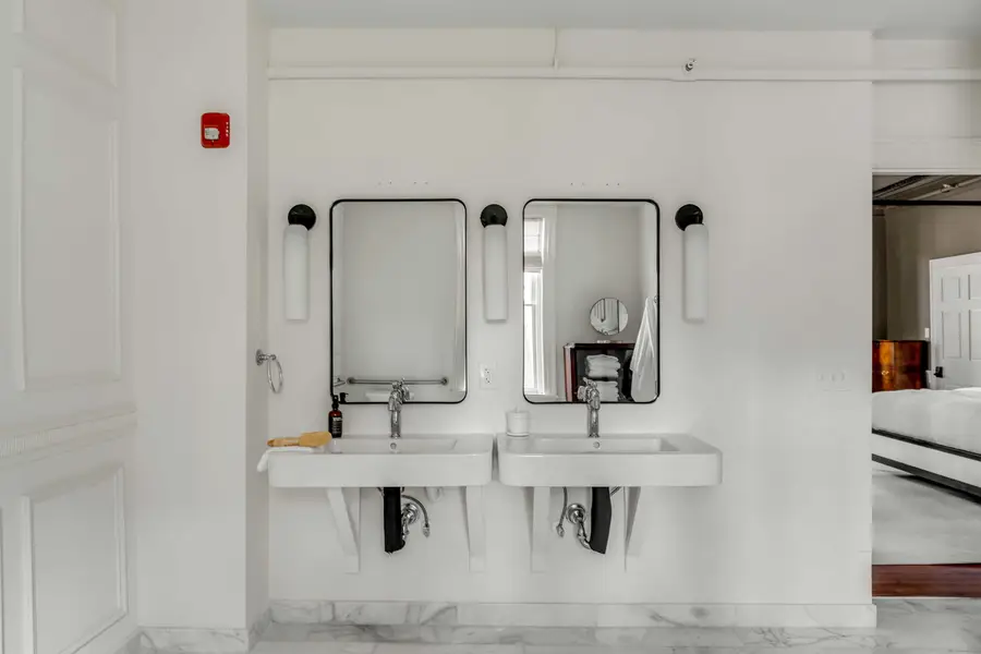 Bathroom #1: Indulge in a spa-like retreat featuring a soaking tub, walk-in shower, dual vanities, plush bathrobes, and elegant luxury finishes.