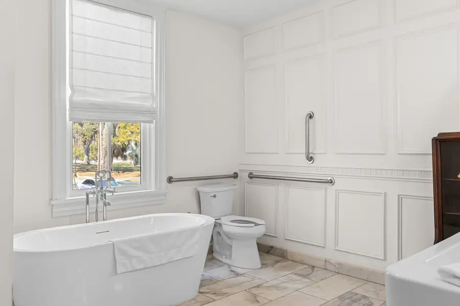 Bathroom #1: Indulge in a spa-like retreat featuring a soaking tub, walk-in shower, dual vanities, plush bathrobes, and elegant luxury finishes.